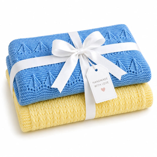 Gift wrapped Corn Rows and Little Boats baby blanket knitting pattern bundle with blue and pastel yellow textured knitted blankets tied with a white satin ribbon and tag on a soft white background