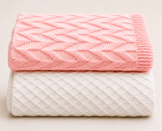 Easy Knit & Purl Baby Blankets folded pink and white parallel lines textured blankets on a light background
