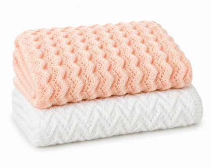 Folded peach zigzag and white arrow textured knitted baby blankets