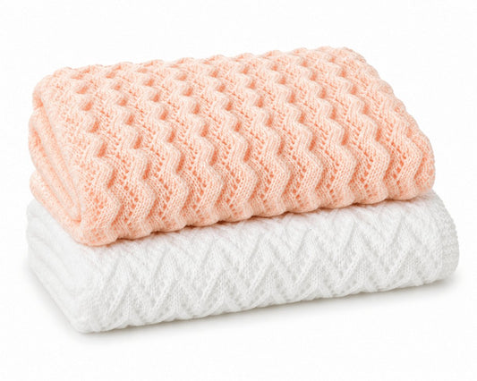 Folded peach zigzag and white arrow textured knitted baby blankets
