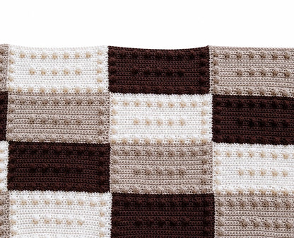 Crochet blanket made from puff stitch practice blocks in cream, taupe and chocolate colours