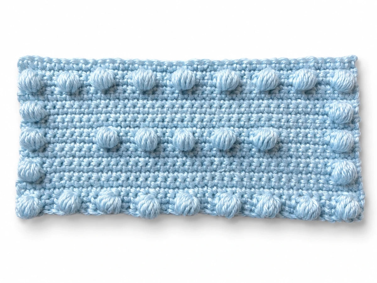 Blue crochet puff stitch practice motif with border and centre puff stitches