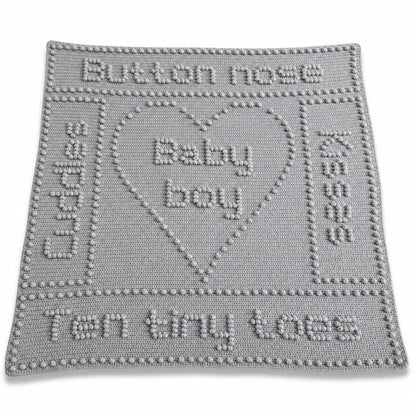 Button Nose baby blanket crochet pattern with heart motif, baby-themed wording and textured crochet design.