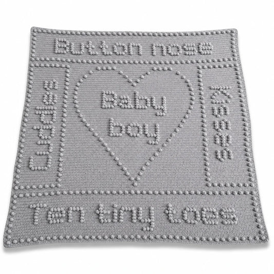 Button Nose baby blanket crochet pattern with heart motif, baby-themed wording and textured crochet design.