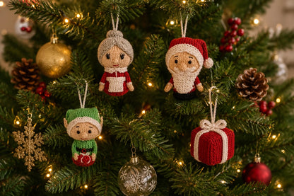 Knitted Santa, Mrs Claus, Elf and Present Christmas decorations hanging on a decorated Christmas tree