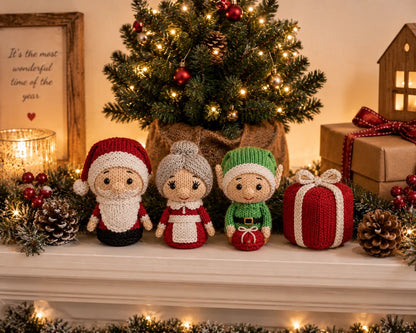 Knitted Santa, Mrs Claus, Elf and Present Christmas decorations displayed beneath a tabletop Christmas tree on a mantelpiece
