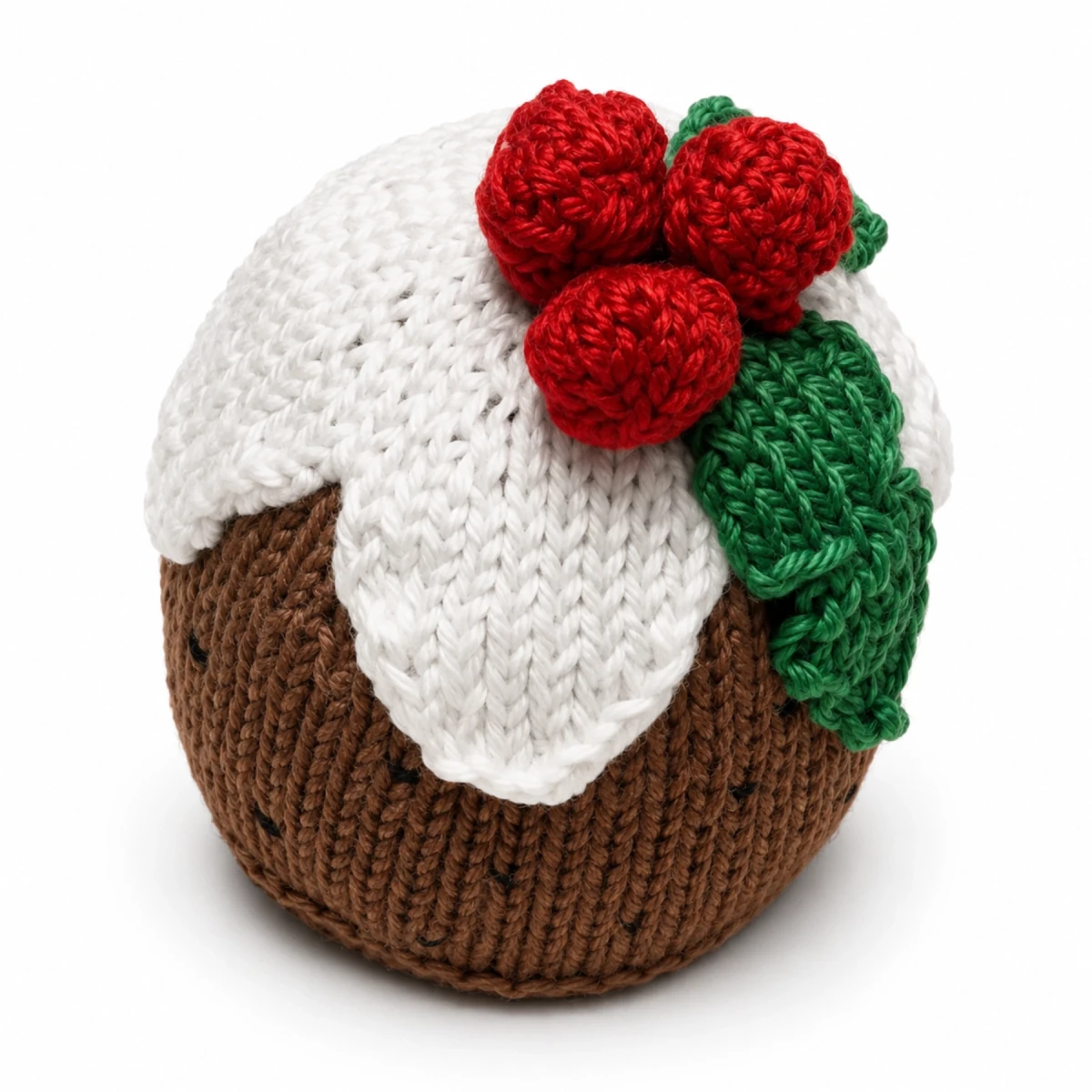 Handmade knitted Christmas pudding decoration on a white background with soft shadow for a free worked flat Christmas knitting pattern