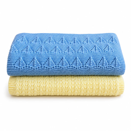 Folded blue and pastel yellow baby blanket knitting pattern bundle with textured Little Boats and Corn Rows stitch patterns on a white background with soft shadow