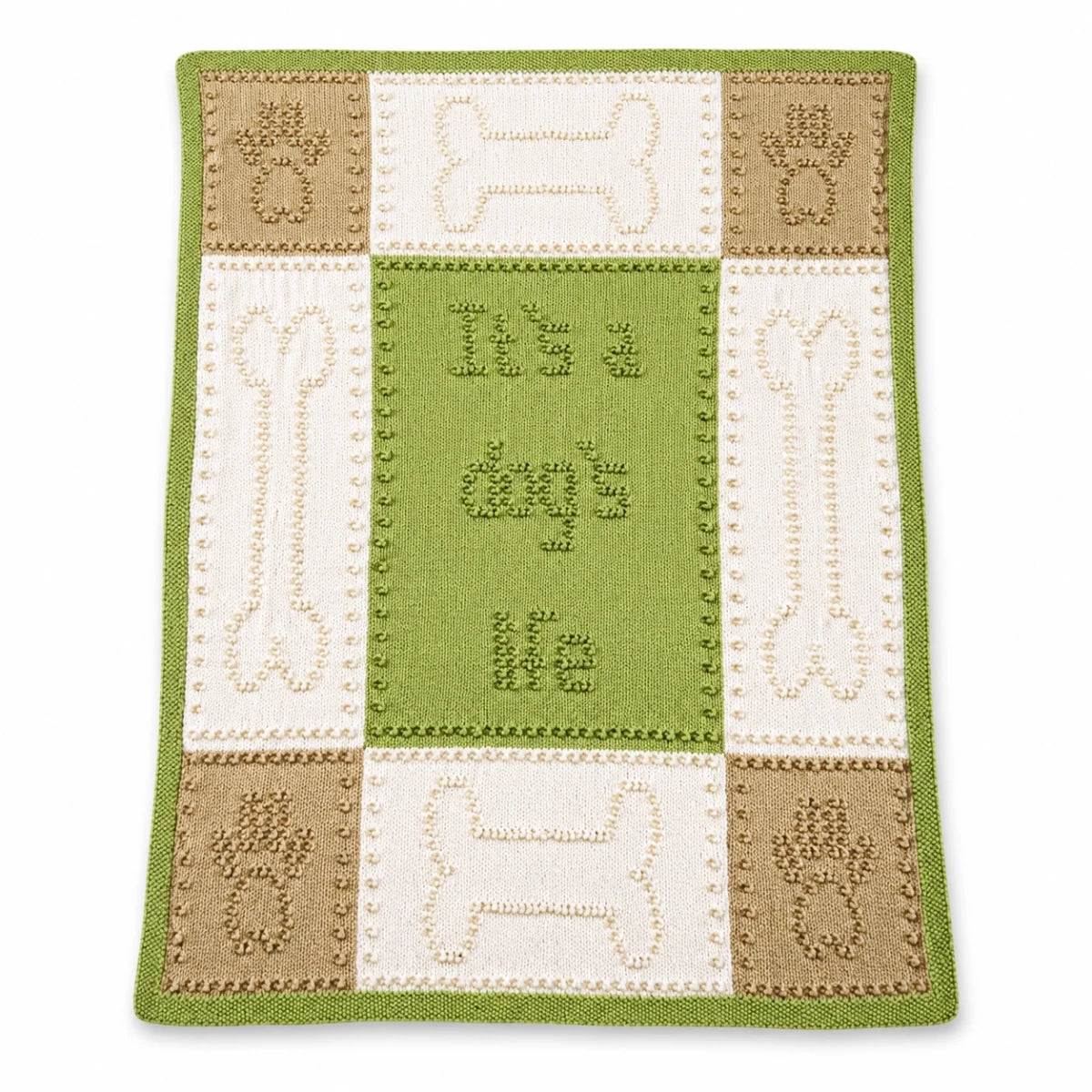 Dog Life baby blanket knitting pattern in green, cream and beige with paw print and bone motifs displayed on a white background with soft shadow.