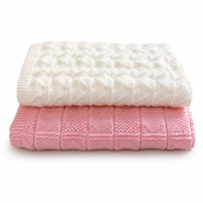 Easy baby blanket knitting pattern bundle featuring cream Interlocking blanket and pink Diamond Squares blanket folded on white background with soft shadow
