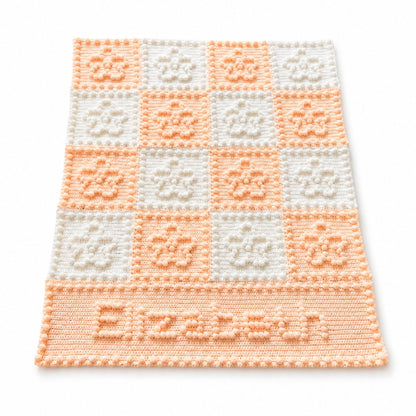 Personalised crochet blanket with puff stitch flower squares and the name Elizabeth