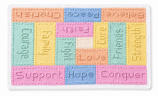 Pastel knitted cancer support lap blanket featuring comforting words including Hope, Strength, Courage and Love in textured knit panels on a soft cream border.