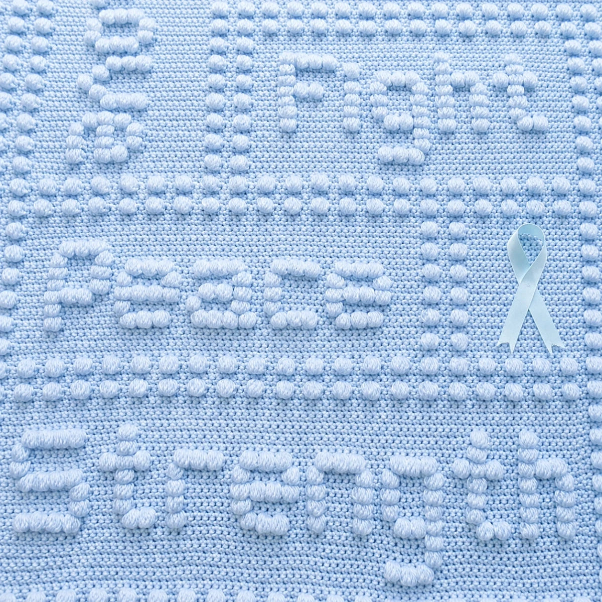 Close-Up of Free Cancer Support One-Piece Crochet Lap Blanket Pattern in Soft Blue Showing Peace and Strength