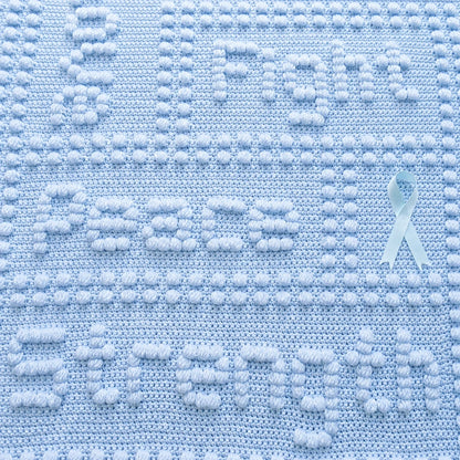Close-Up of Free Cancer Support One-Piece Crochet Lap Blanket Pattern in Soft Blue Showing Peace and Strength