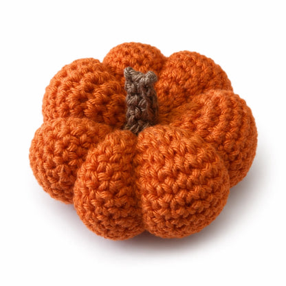 Free crochet pumpkin pattern showing a small handmade autumn pumpkin decoration on a white background