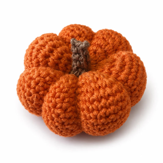 Free crochet pumpkin pattern showing a small handmade autumn pumpkin decoration on a white background