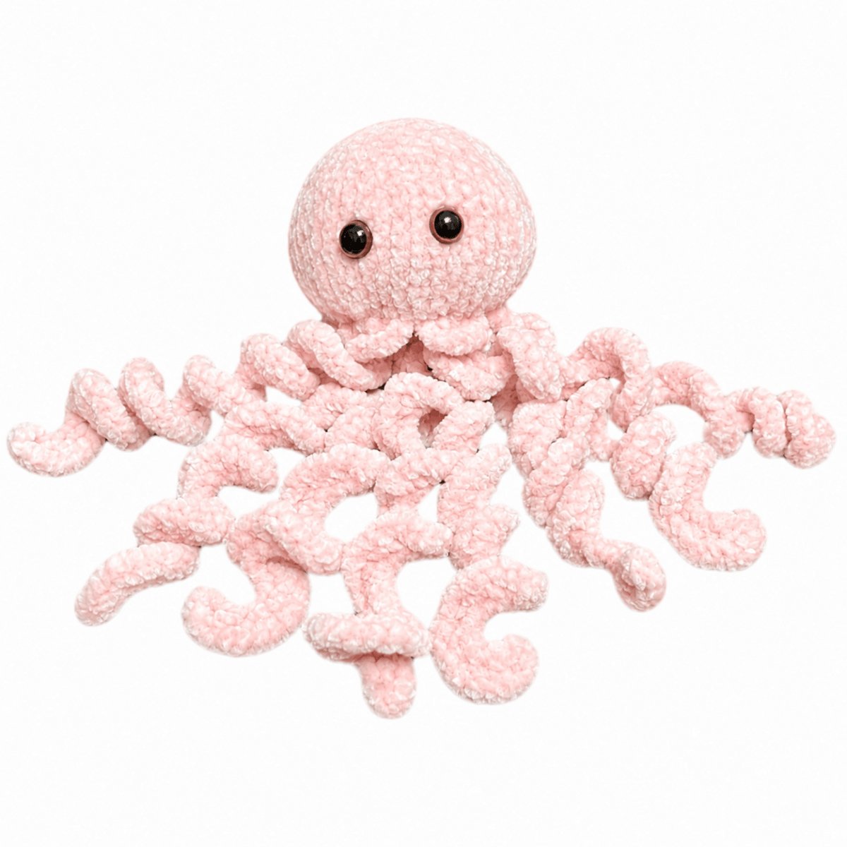 Soft pink knitted jellyfish plush toy made from fluffy yarn using the Peach Unicorn Designs free jellyfish knitting pattern.