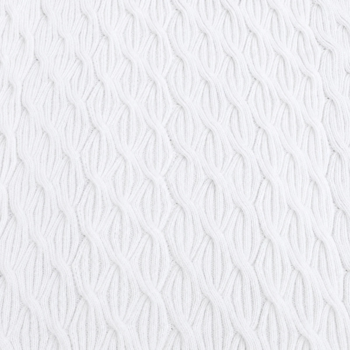 Close-up of a white Rainbow Waves baby blanket showing the raised ribbed cable pattern and knitted texture