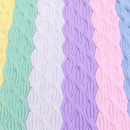 Close-up of Rainbow Waves baby blanket showing pastel cable knitting pattern in yellow, mint, lilac, purple, pink and blue stripes