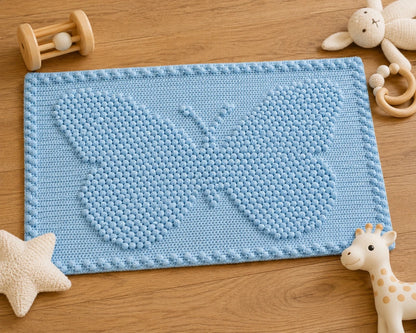 Blue small butterfly crochet baby blanket with bobble stitch design and wooden baby toys