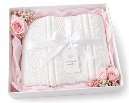 White granite cable baby blanket in a white gift box with flowers