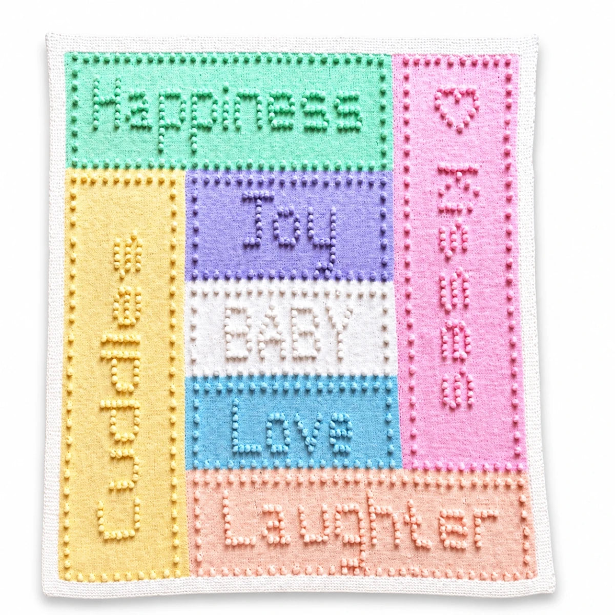 Joy baby blanket knitting pattern featuring intarsia panels with bobble lettering in soft pastel colours on a white background