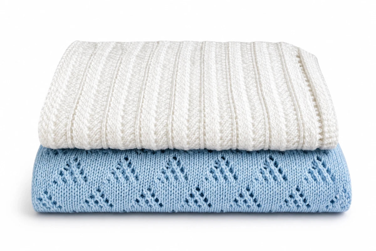 Folded white and blue lace baby blankets stacked together on a white background featuring the Lacy Lanes and Lacy Triangles knitting pattern bundle for beginners.