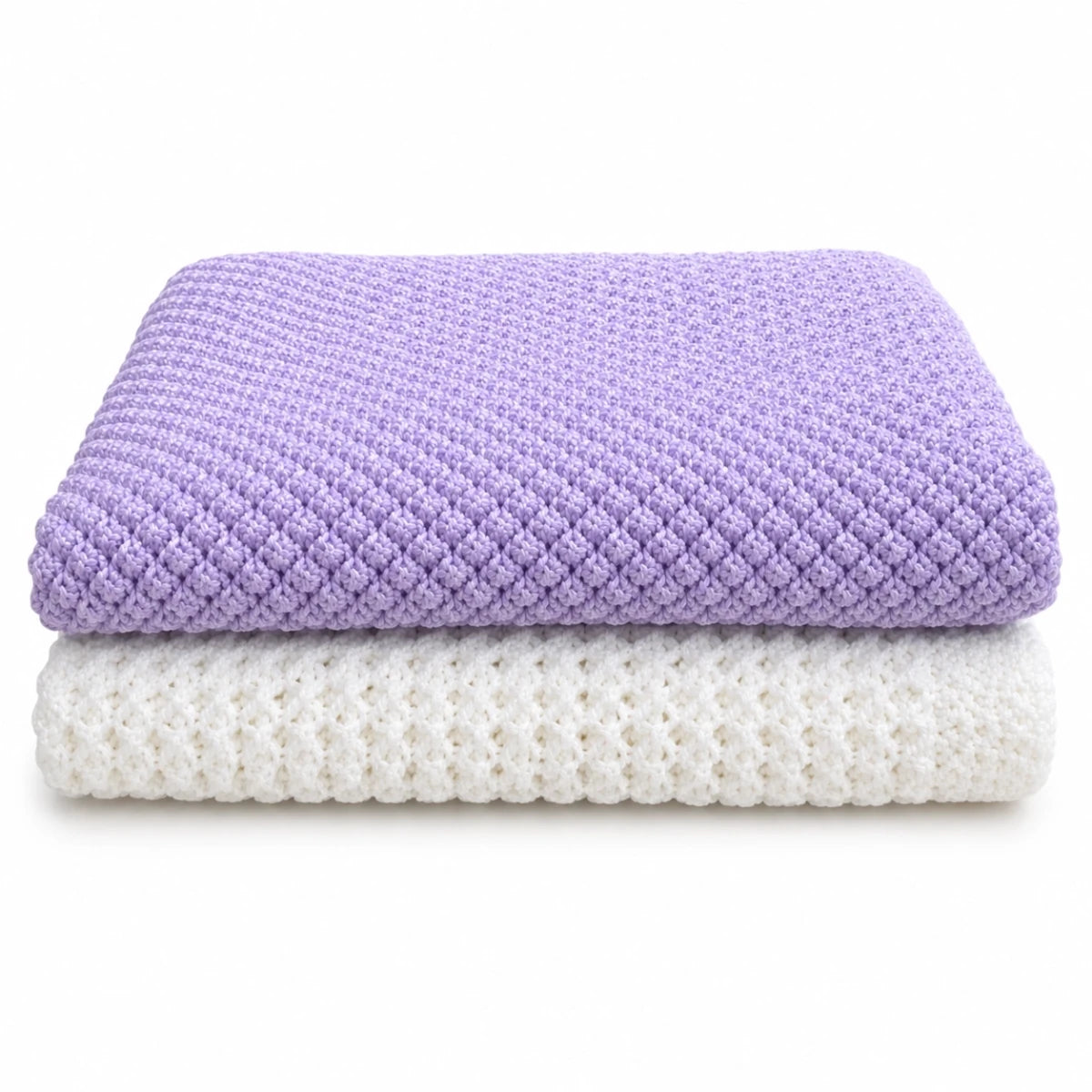 Folded lilac Blackberry baby blanket stacked on white Lattice Love baby blanket knitting pattern bundle on a white background
