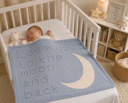 Love You to the Moon and Back baby blanket draped over a sleeping baby in a neutral nursery with antique white moon motif