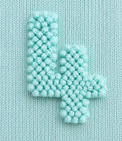 Close-up of the bobble stitch number 4 on the Numbers Baby Blanket knitting pattern