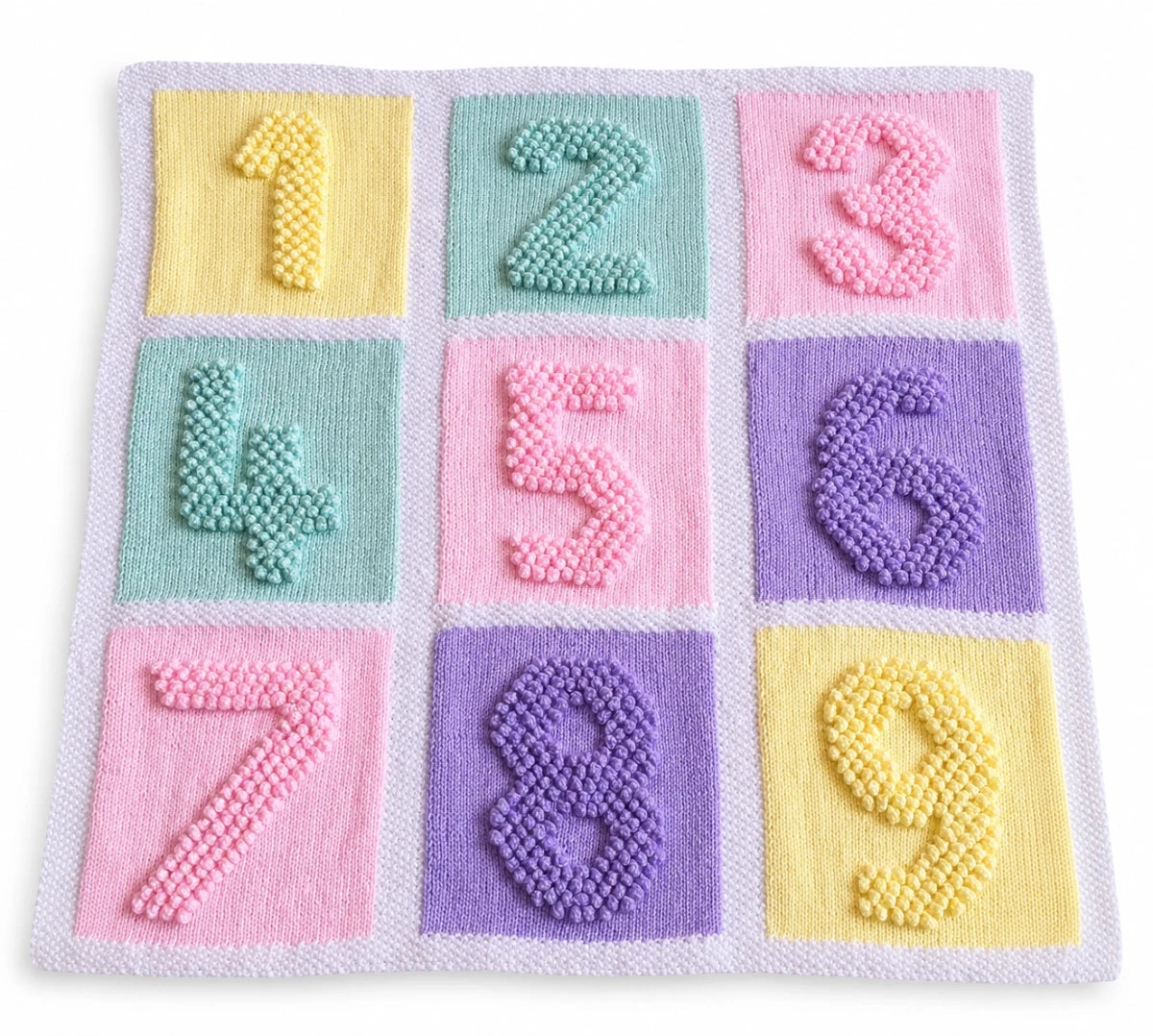 Number Squares baby blanket knitting pattern with pastel bobble-stitch number squares