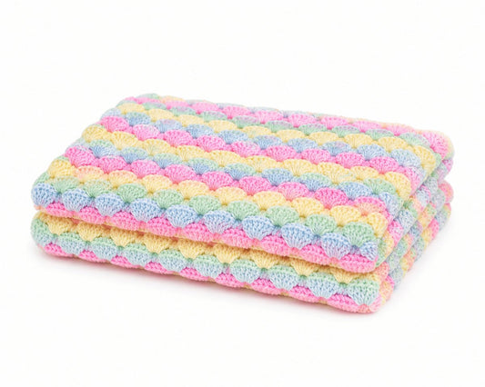 Folded pastel shell stitch crochet baby blanket in pink blue yellow and mint colours