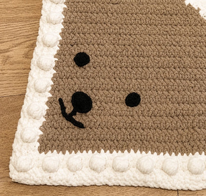 Close-up of the bear face and textured bobble border on the Peekaboo Baby Blanket crochet pattern.