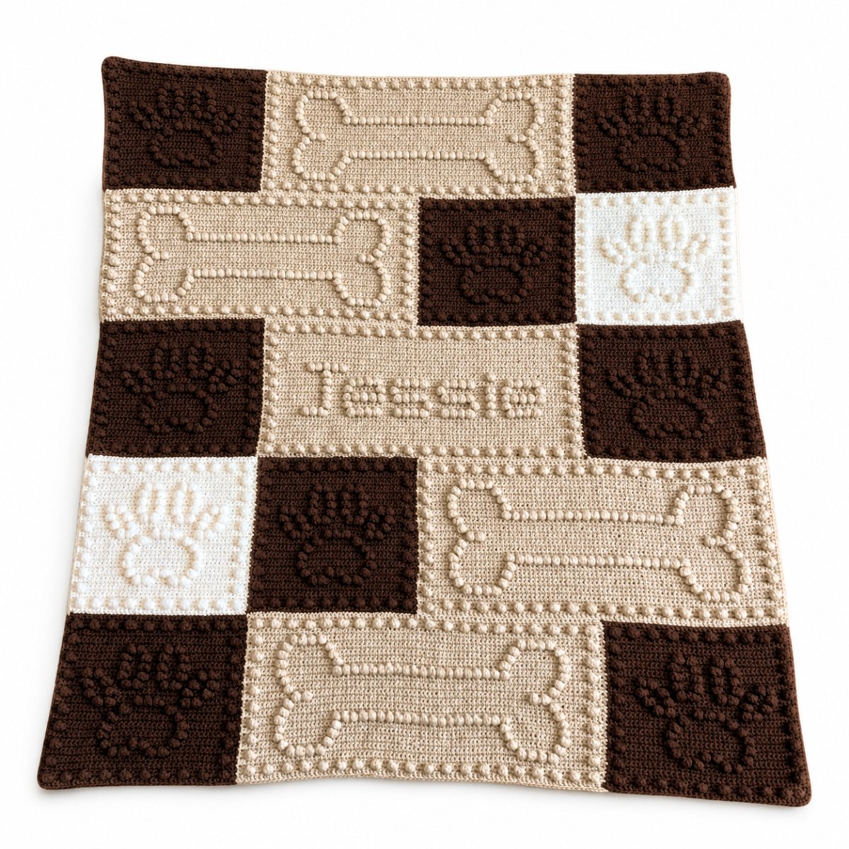 Personalised crochet dog blanket with paw prints bones and the name Jessie
