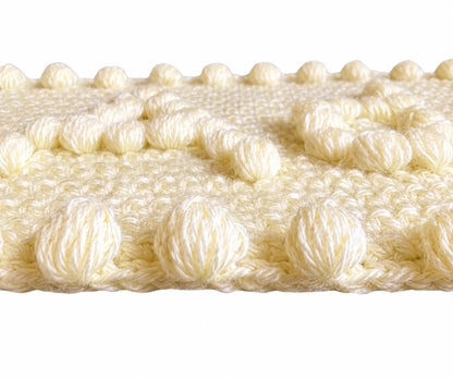 Close-up of the puff stitch texture and border detail on the Precious Motifs Baby Blanket crochet pattern showing raised crochet stitches.