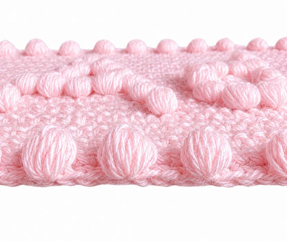 Close-up of soft pink puff stitch border and texture on the Precious One-Piece Baby Blanket crochet pattern.