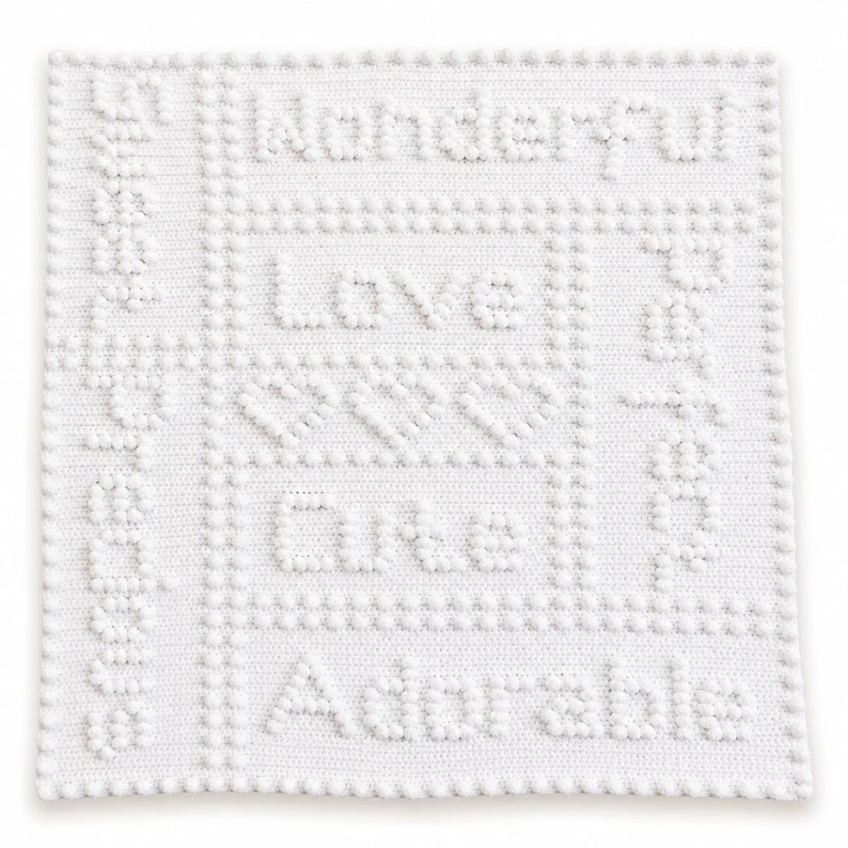 White Precious One-Piece Baby Blanket crochet pattern showing puff stitch wording, hearts and border on a white background.