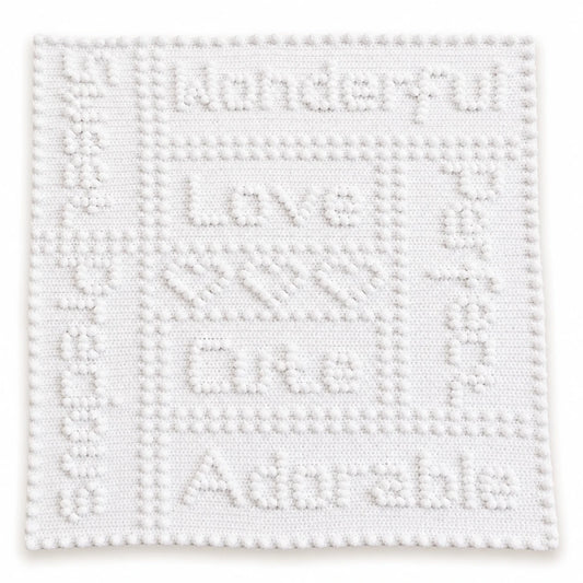 White Precious One-Piece Baby Blanket crochet pattern showing puff stitch wording, hearts and border on a white background.