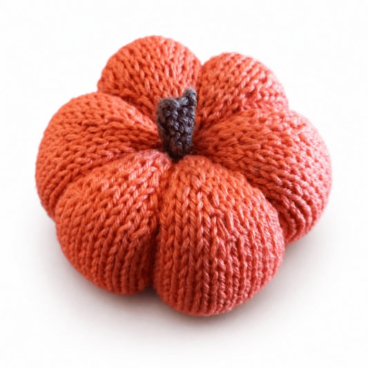 Orange knitted pumpkin made using a worked flat pumpkin knitting pattern