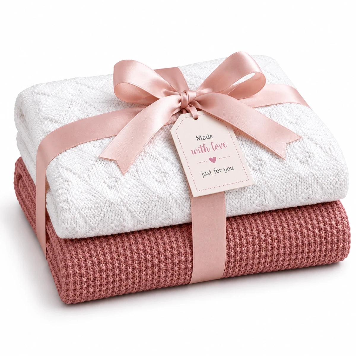 Gift wrapped baby blanket knitting pattern bundle featuring the Rice Stitch and Diamonds Are Forever knitted blankets with soft pink ribbon and handmade gift tag on a white background.