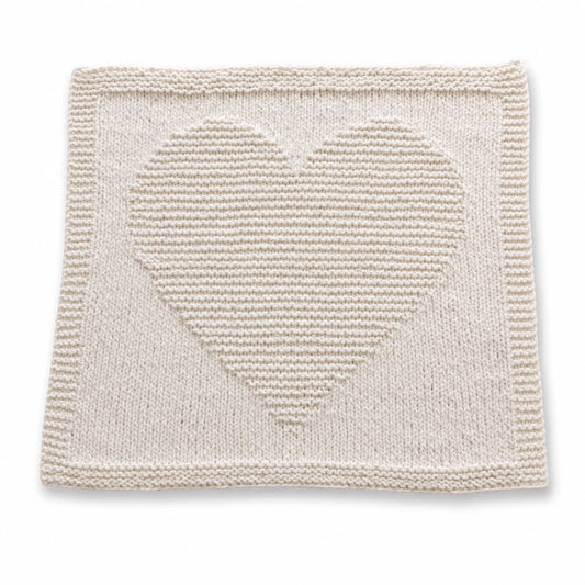 Simple Chunky Heart Baby Blanket knitting pattern in vanilla super chunky yarn with raised heart motif and garter stitch border