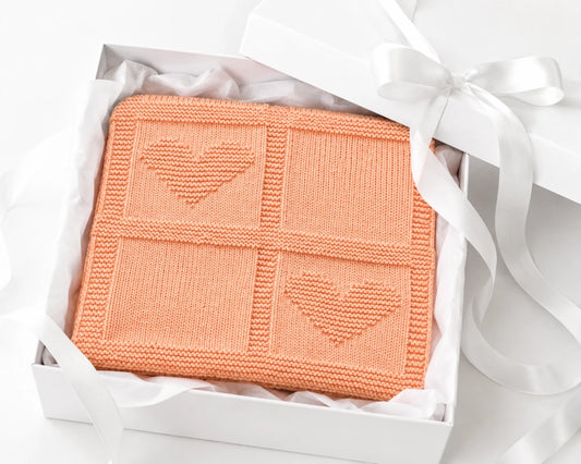 Simple Hearts Baby Blanket folded in a luxury white gift box with tissue paper and satin ribbon