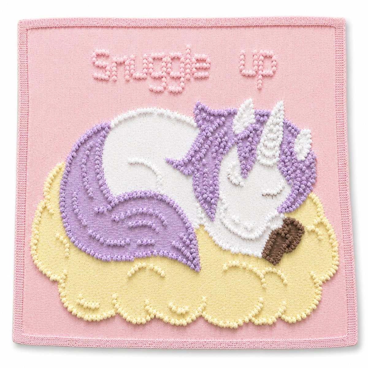 Sleeping Peach Unicorn baby blanket knitting pattern in pastel pink, lilac and soft lemon colours with textured unicorn design and Snuggle Up wording
