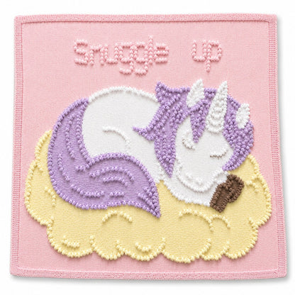 Sleeping Peach Unicorn baby blanket knitting pattern in pastel pink, lilac and soft lemon colours with textured unicorn design and Snuggle Up wording