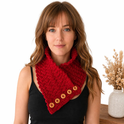 Woman wearing the Sparkling Basketweave Neckwarmer knitting pattern featuring basketweave texture, decorative buttons and a cosy fitted design.