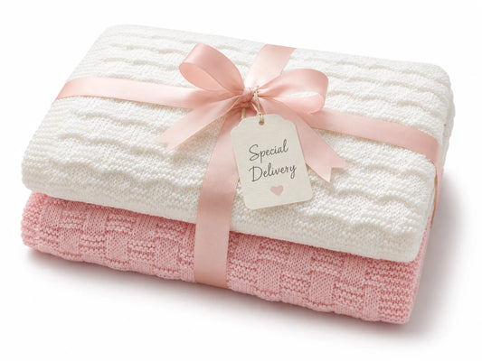 Gift wrapped white and pink baby blanket knitting pattern bundle with pastel ribbon and Special Delivery gift tag on a white background