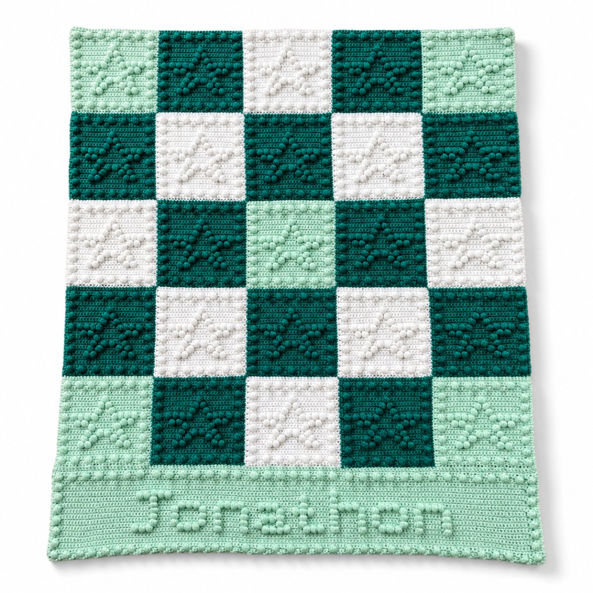 Personalised crochet baby blanket with puff stitch stars and the name Jonathon