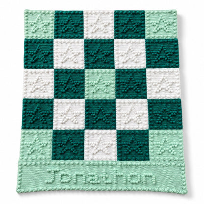 Personalised crochet baby blanket with puff stitch stars and the name Jonathon