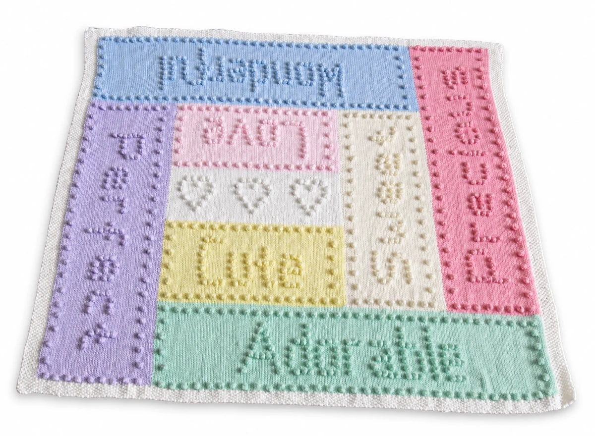 Sweet Dreams baby blanket knitting pattern with pastel bobble-stitch words and heart details