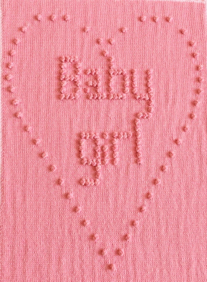 Close-up of Ten Tiny Toes baby blanket showing baby girl bobble stitch heart motif and textured lettering
